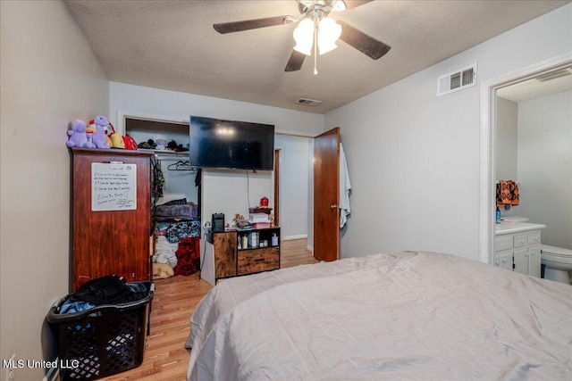 2880 Briarwood Dr, Horn Lake, MS 38637 - bedroom with wood finished floors, ceiling fan, and ensuite bath