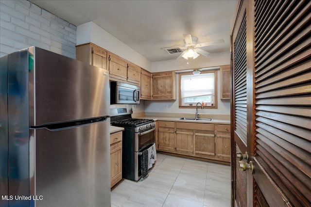 2880 Briarwood Dr, Horn Lake, MS 38637 - kitchen with stainless steel appliances, light countertops, ceiling fan, and light tile patterned floors