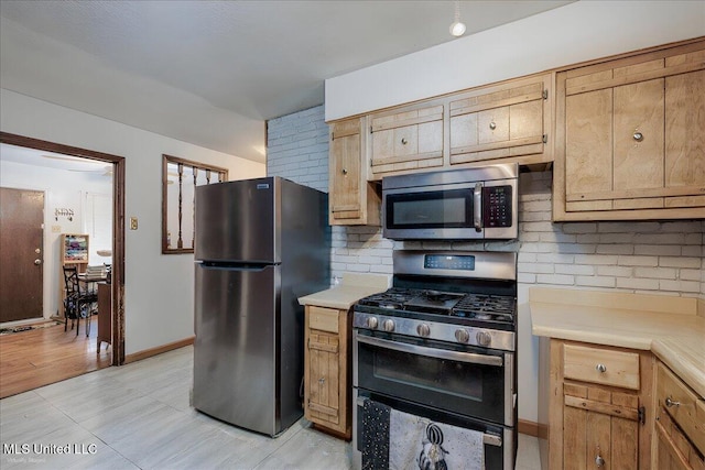 2880 Briarwood Dr, Horn Lake, MS 38637 - kitchen featuring stainless steel appliances, tasteful backsplash, light countertops, and light tile patterned floors