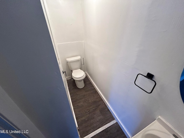 bathroom with toilet and wood-type flooring