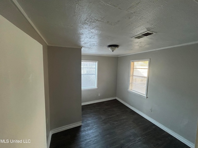 unfurnished room featuring crown molding, a wealth of natural light, and dark hardwood / wood-style floors