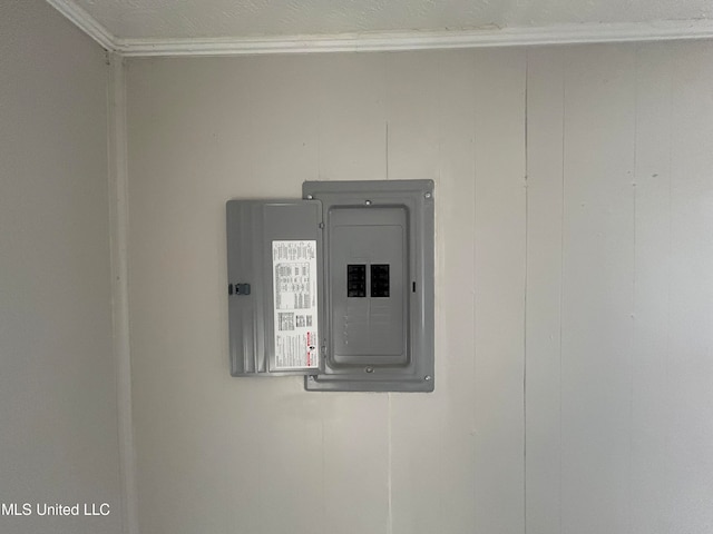 details featuring wood walls, ornamental molding, and electric panel