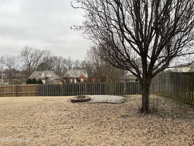 view of yard featuring an outdoor fire pit