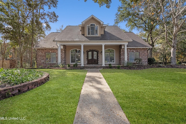 view of front of house with a front yard and a porch