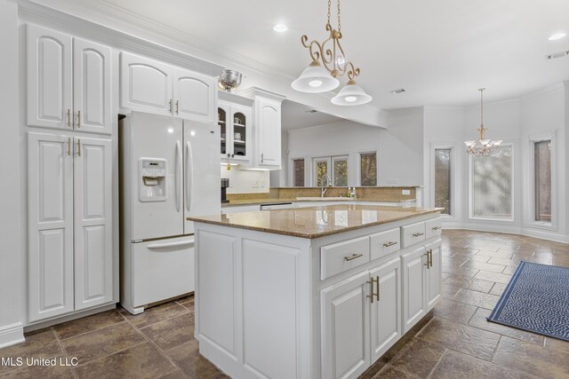 kitchen featuring a kitchen island, sink, pendant lighting, white cabinetry, and white fridge with ice dispenser