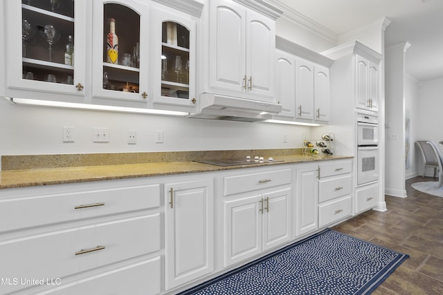 kitchen featuring black electric stovetop, white cabinetry, double oven, and ornamental molding