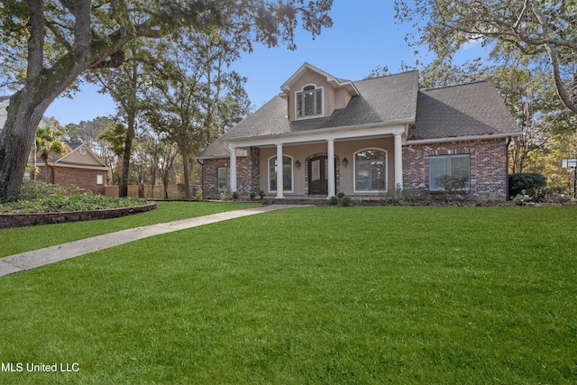 view of front of house featuring covered porch and a front yard