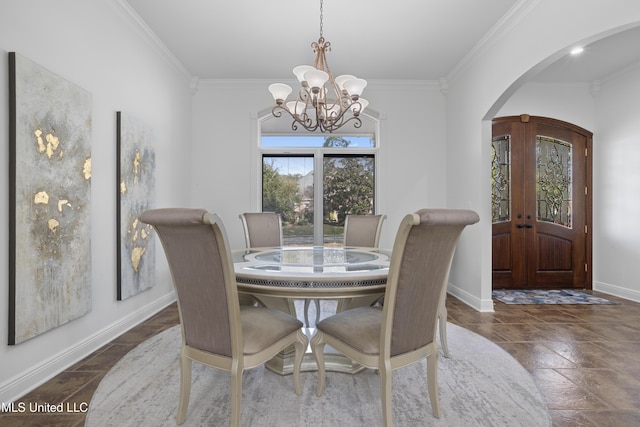 dining room featuring a chandelier, french doors, and crown molding