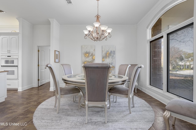 dining room with ornamental molding and a notable chandelier