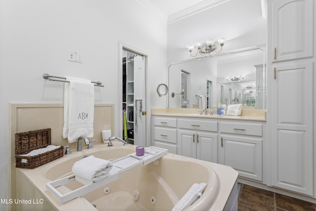 bathroom with a notable chandelier, a bathtub, crown molding, and vanity