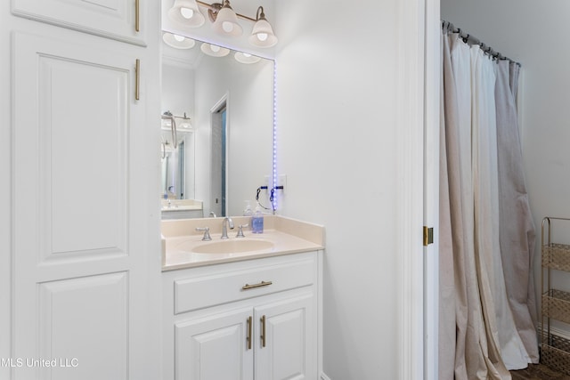 bathroom featuring vanity and ornamental molding