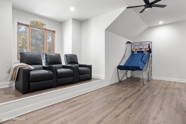 home theater room featuring ceiling fan and light hardwood / wood-style floors