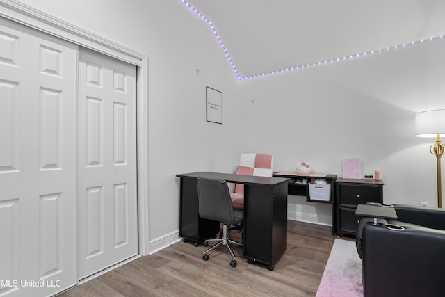 office area featuring hardwood / wood-style floors and vaulted ceiling