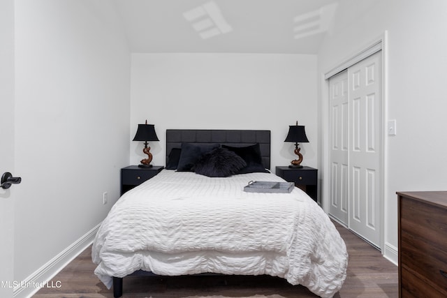 bedroom featuring dark hardwood / wood-style flooring and a closet