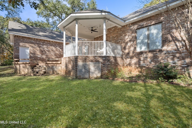 view of property exterior with a lawn and ceiling fan