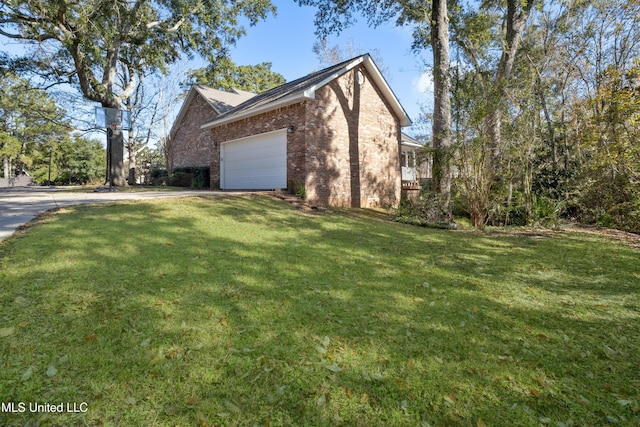 view of side of property featuring a yard and a garage