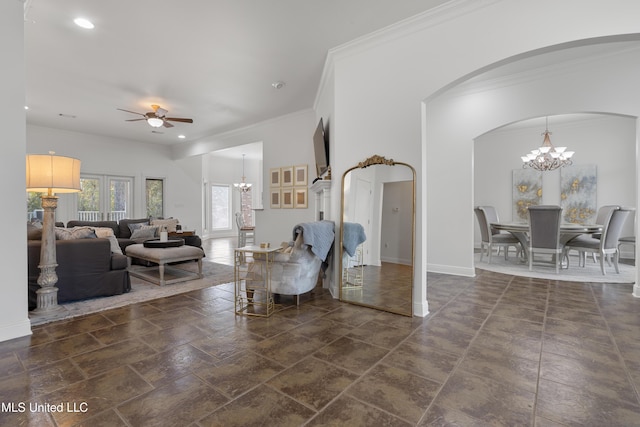 living room with ceiling fan with notable chandelier and ornamental molding