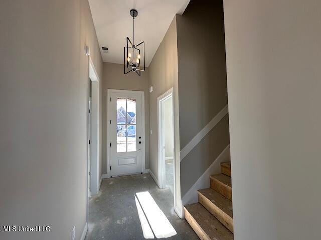 entrance foyer featuring an inviting chandelier