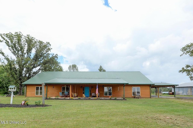 view of front of property featuring a front lawn and a carport