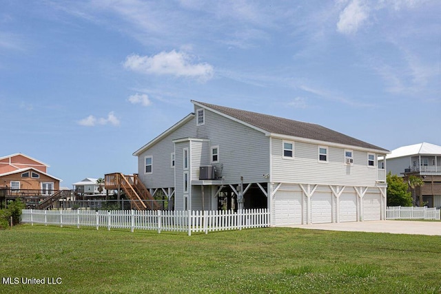 11088 Tahiti St, Bay Saint Louis, MS 39520 - rear view of house with driveway, an attached garage, and stairway