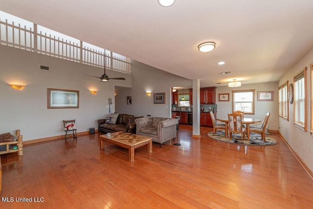 11088 Tahiti St, Bay Saint Louis, MS 39520 - living area with light wood-style flooring, baseboards, and a ceiling fan