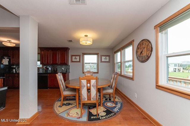 11088 Tahiti St, Bay Saint Louis, MS 39520 - dining area featuring light wood-style flooring and baseboards