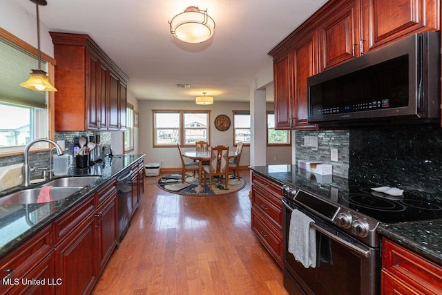 11088 Tahiti St, Bay Saint Louis, MS 39520 - kitchen with stainless steel electric range oven, a sink, dishwasher, light wood finished floors, and decorative backsplash