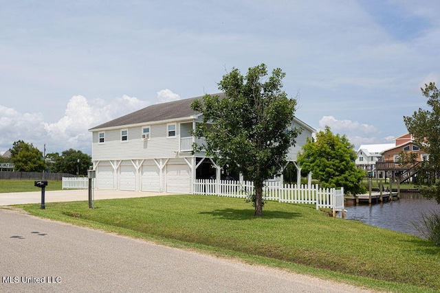 11088 Tahiti St, Bay Saint Louis, MS 39520 - view of front facade with driveway, a water view, and an attached garage