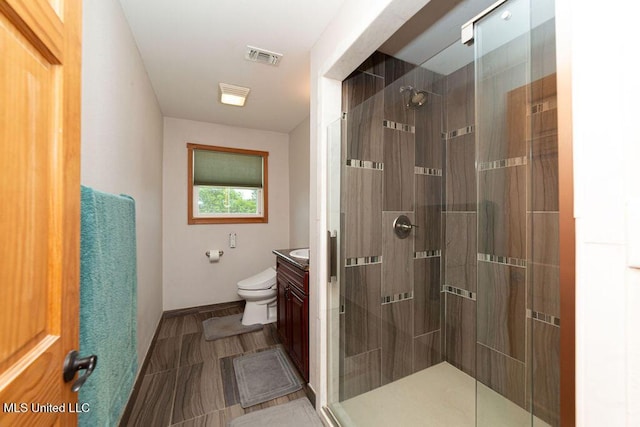 11088 Tahiti St, Bay Saint Louis, MS 39520 - full bathroom with vanity, a stall shower, toilet, and baseboards