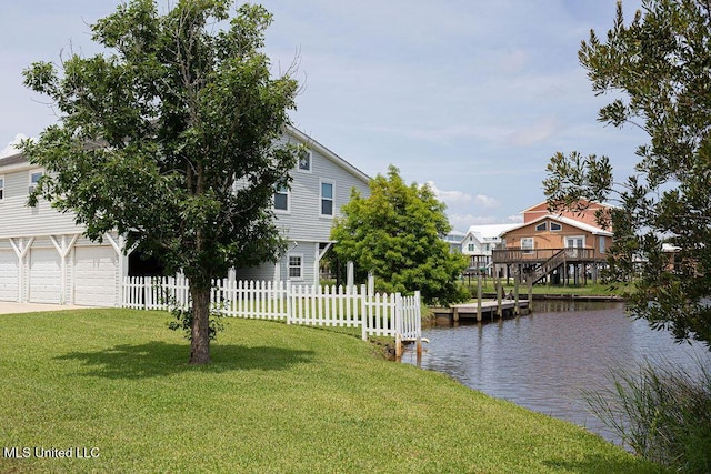 11088 Tahiti St, Bay Saint Louis, MS 39520 - view of yard with a water view, a garage, and driveway