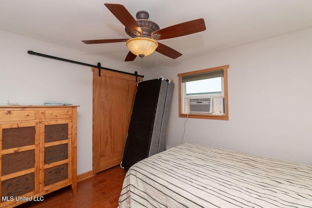11088 Tahiti St, Bay Saint Louis, MS 39520 - bedroom with cooling unit, dark wood-style flooring, a barn door, and a ceiling fan