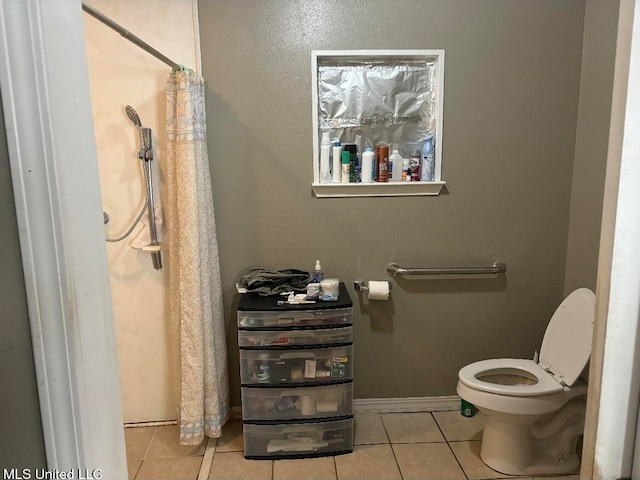 bathroom with toilet, tile patterned floors, and a shower with shower curtain