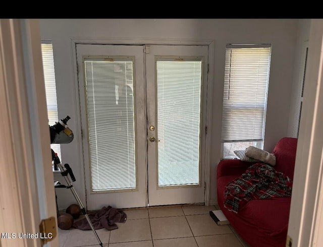 doorway with french doors and light tile patterned floors