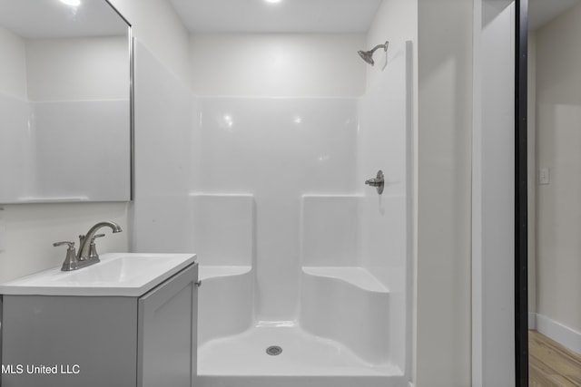 175 Saint Charles Ave, Biloxi, MS 39530 - full bathroom with vanity, a shower, and wood finished floors