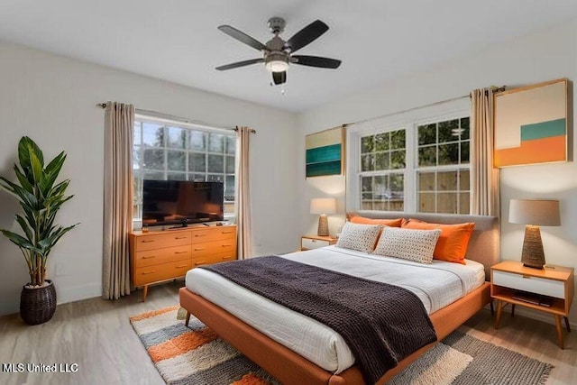 175 Saint Charles Ave, Biloxi, MS 39530 - bedroom with light wood-style floors, multiple windows, and ceiling fan
