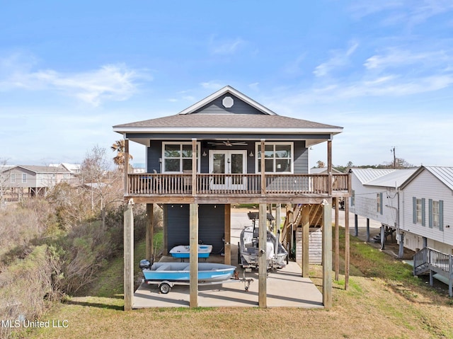 rear view of property featuring a lawn and covered porch