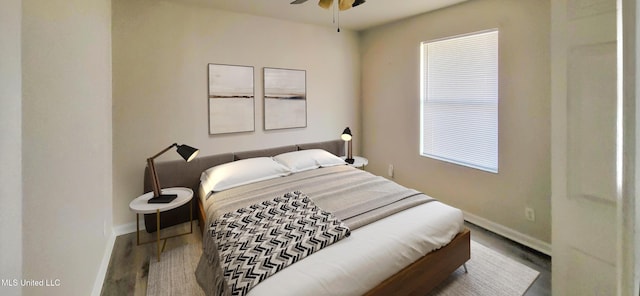 bedroom featuring wood finished floors and baseboards