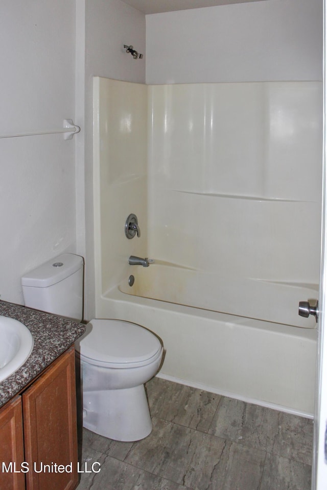 bathroom featuring shower / bathing tub combination, toilet, and vanity