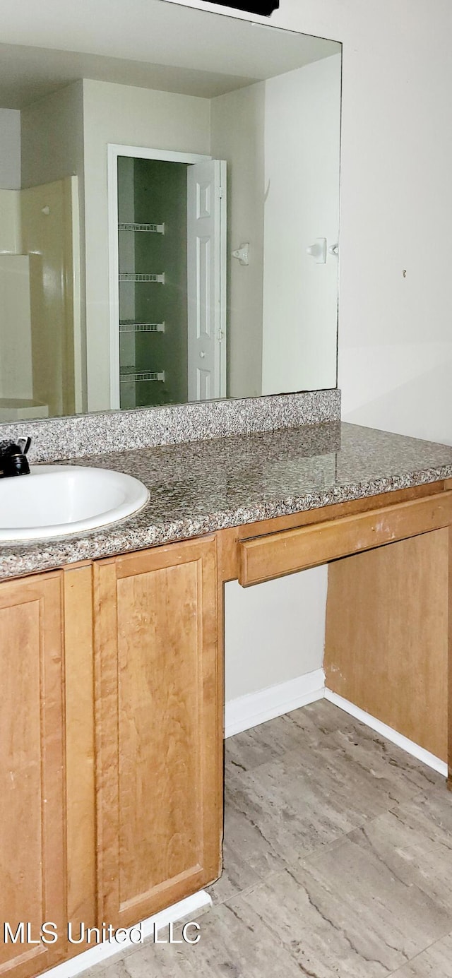 bathroom with vanity and wood finished floors