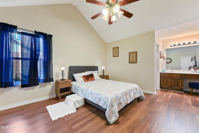 14174 Spruce Ct, Gulfport, MS 39503 - bedroom featuring wood finished floors, baseboards, ceiling fan, high vaulted ceiling, and connected bathroom