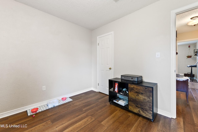 14174 Spruce Ct, Gulfport, MS 39503 - unfurnished room featuring dark wood-style floors, baseboards, and a textured ceiling