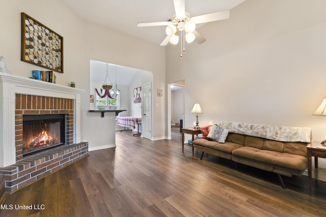 14174 Spruce Ct, Gulfport, MS 39503 - living area with wood finished floors, vaulted ceiling, a ceiling fan, baseboards, and a brick fireplace