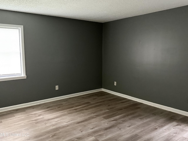 5704 Westminister Ln, Southaven, MS 38671 - empty room featuring wood finished floors and a textured ceiling
