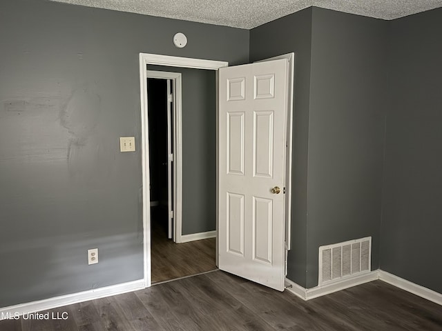 5704 Westminister Ln, Southaven, MS 38671 - unfurnished bedroom with wood finished floors and a textured ceiling