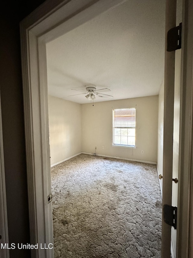 unfurnished room featuring carpet flooring and ceiling fan