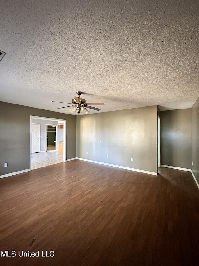 spare room with wood-type flooring, a textured ceiling, and ceiling fan