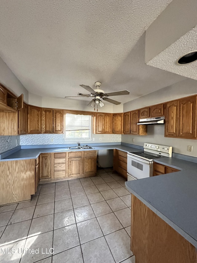 kitchen featuring sink, electric range, ceiling fan, light tile patterned floors, and a textured ceiling