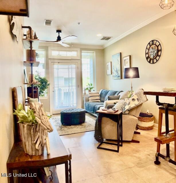 living room featuring ceiling fan, crown molding, and light tile patterned floors