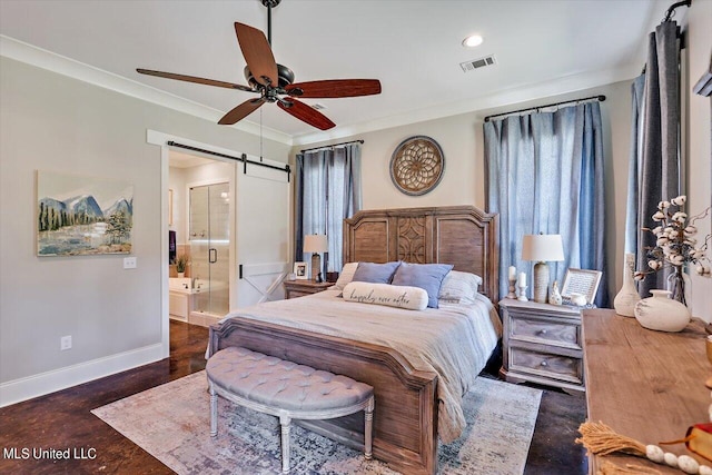 bedroom featuring a barn door, multiple windows, ensuite bathroom, and ceiling fan