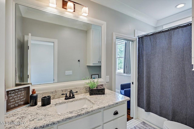 full bathroom with vanity, toilet, and shower / tub combo